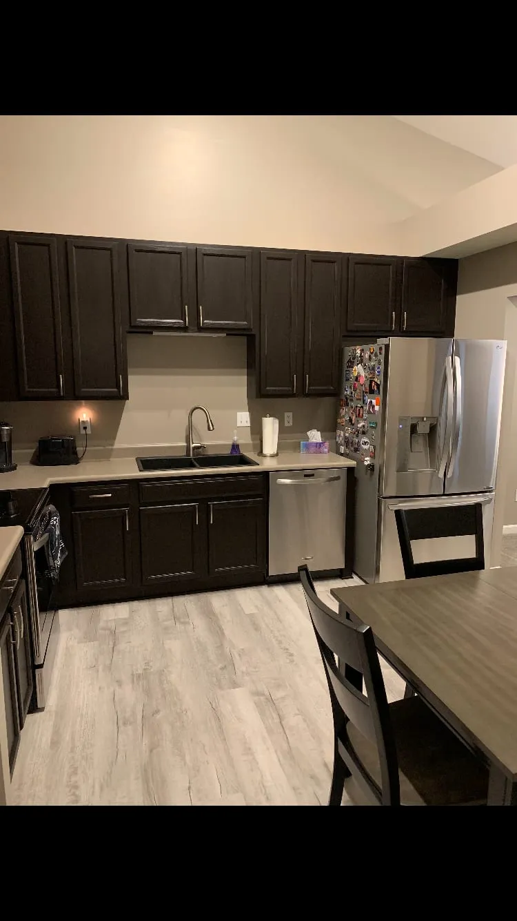 Kitchen cabinets refinished in a rich dark brown