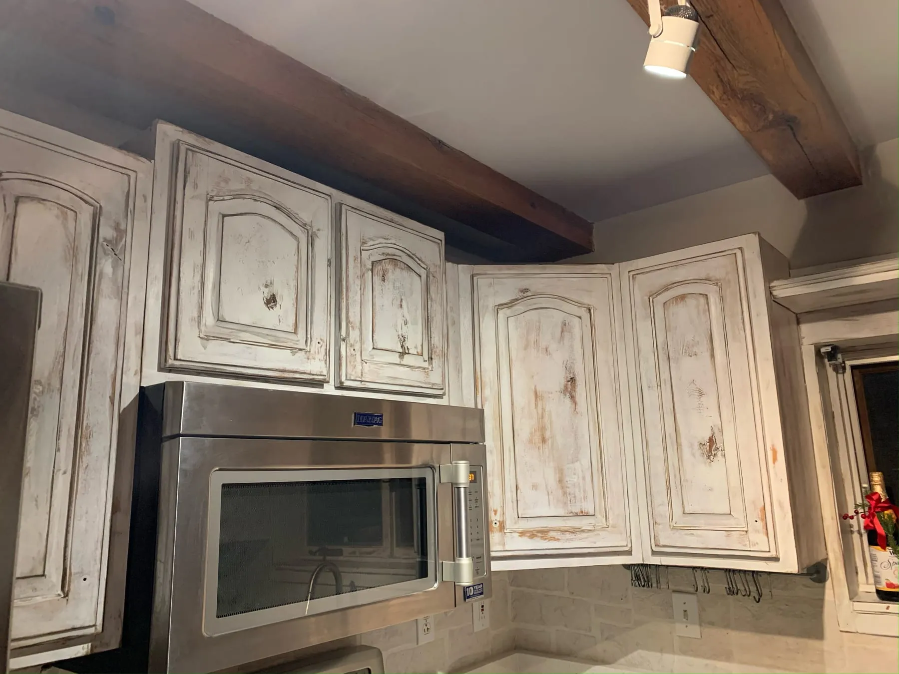 Distressed antique-white French-country cabinets